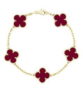 gold bracelet with red clovers