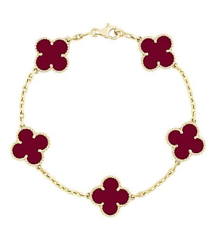 gold bracelet with red clovers